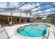 The beautiful screened-in pool features an attached spa, ample patio space, and wooden accents at 3055 Dellcrest Pl, Lake Mary, FL 32746