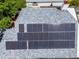 An aerial view of the roof shows solar panels, grey shingles, and surrounding trees at 3055 Dellcrest Pl, Lake Mary, FL 32746