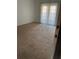 View of bedroom with tan carpet and sunny window at 315 Wymore Rd # 104, Altamonte Springs, FL 32714