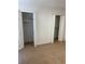 View of bedroom with tan carpet and two closets with white doors at 315 Wymore Rd # 104, Altamonte Springs, FL 32714