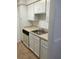 Galley kitchen featuring white cabinets and a stainless-steel sink at 315 Wymore Rd # 104, Altamonte Springs, FL 32714