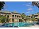 View of an outdoor swimming pool with a multi-story building in the background at 315 Wymore Rd # 104, Altamonte Springs, FL 32714