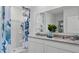 Well-lit bathroom with dual sinks, modern fixtures, and a shower with elegant tiling at 3346 Wakefield Dr, Haines City, FL 33844