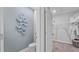 Powder room bathroom leading to closet featuring stylish blue accents, adjacent to a walk-in closet at 3346 Wakefield Dr, Haines City, FL 33844