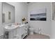 Elegant powder room featuring a pedestal sink, modern fixtures, and stylish wall art for a refined aesthetic at 3346 Wakefield Dr, Haines City, FL 33844
