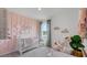 Charming Bedroom with pink accent wall, plush decor, and a delightful cloud design providing a cozy space at 3346 Wakefield Dr, Haines City, FL 33844