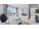 Cozy bedroom offers natural light through a large window with complementing blue accents and stylish decor at 3346 Wakefield Dr, Haines City, FL 33844