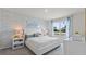 Serene bedroom with light blue wallpaper, a plush bed, and ample natural light at 3346 Wakefield Dr, Haines City, FL 33844