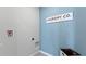 Efficient laundry room with blue accent wall, featuring modern design and functional space, ready for chores at 3346 Wakefield Dr, Haines City, FL 33844
