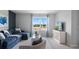 Bright living room with stylish blue sofa, coastal artwork, and abundant natural light at 3346 Wakefield Dr, Haines City, FL 33844