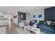 Open-concept living space with white accents, coastal decor, and seamless flow to the kitchen at 3346 Wakefield Dr, Haines City, FL 33844