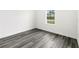 Bright bedroom showcasing wood-look floors and a window offering natural light at 3420 Sw 130Th Lane Rd, Ocala, FL 34473