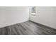 Bright bedroom showcasing wood-look floors and a window offering natural light at 3420 Sw 130Th Lane Rd, Ocala, FL 34473