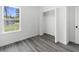 An empty bedroom with a closet, window, and wood floors at 3420 Sw 130Th Lane Rd, Ocala, FL 34473