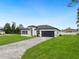Attractive single-story home featuring a long brick driveway and meticulously maintained front lawn at 3420 Sw 130Th Lane Rd, Ocala, FL 34473