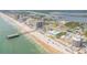 Panoramic aerial view features a condo, a pier, and beautiful beachfront scenery at 3641 S Atlantic Ave # 110, Daytona Beach, FL 32118