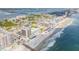 Stunning aerial view showcases a beachside condo with a pool, pier and direct ocean access at 3641 S Atlantic Ave # 110, Daytona Beach, FL 32118