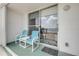 Cozy ocean view balcony featuring comfortable seating and sliding glass doors at 3641 S Atlantic Ave # 110, Daytona Beach, FL 32118