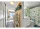 Hallway leading to the bathroom and a view of the living area at 3641 S Atlantic Ave # 110, Daytona Beach, FL 32118