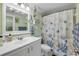 Bathroom featuring a white vanity and tiled shower at 3641 S Atlantic Ave # 110, Daytona Beach, FL 32118