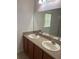 The bathroom features a double sink vanity with a large mirror at 3651 Sail Harbor Dr, Kissimmee, FL 34746