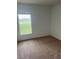 Cozy bedroom with plush carpeting and a large window overlooking a serene outdoor view at 3651 Sail Harbor Dr, Kissimmee, FL 34746
