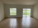 Bright living room features sliding glass doors with a serene view, and tiled flooring at 3651 Sail Harbor Dr, Kissimmee, FL 34746
