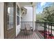 Cozy balcony with chair and table, black metal railing, and view of the street at 439 Windmill Palm Cir, Altamonte Springs, FL 32701