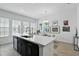 Bright kitchen featuring quartz countertops, center island, and stainless steel appliances with modern finishes at 439 Windmill Palm Cir, Altamonte Springs, FL 32701
