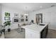 Bright kitchen and dining area featuring quartz countertops, stainless steel appliances, and modern finishes at 439 Windmill Palm Cir, Altamonte Springs, FL 32701