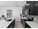 Bright kitchen featuring quartz countertops, stainless steel appliances, and black cabinets at 439 Windmill Palm Cir, Altamonte Springs, FL 32701