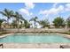 A serene community pool with lounge chairs offers relaxation and recreation under the sunny sky at 439 Windmill Palm Cir, Altamonte Springs, FL 32701