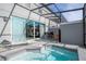 View of an enclosed patio and backyard featuring a spa, lounge area, and outdoor dining at 4414 Le Reve Ct, Kissimmee, FL 34746