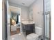 Modern bathroom features a sleek vanity, square mirror, and stylish tile flooring at 4414 Le Reve Ct, Kissimmee, FL 34746