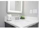 Close-up of modern sink and vanity in the bathroom featuring a contemporary mirror, fixtures, and stylish decor at 4414 Le Reve Ct, Kissimmee, FL 34746