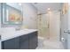 This bathroom has a large framed mirror, and modern shower with gray cabinets at 4414 Le Reve Ct, Kissimmee, FL 34746