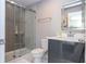 Bathroom features tiled shower with glass doors and modern vanity with illuminated mirror at 4414 Le Reve Ct, Kissimmee, FL 34746