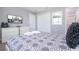 This bedroom has a mounted tv, a dresser, and comfortable gray decor at 4414 Le Reve Ct, Kissimmee, FL 34746