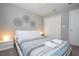This bedroom has a closet and white trim, plus unique geometric artwork at 4414 Le Reve Ct, Kissimmee, FL 34746