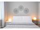 This bedroom has geometric artwork above the bed and modern lighting at 4414 Le Reve Ct, Kissimmee, FL 34746