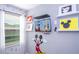 This bedroom is decorated with colorful Mickey Mouse themed wall decor at 4414 Le Reve Ct, Kissimmee, FL 34746