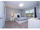 This bedroom has a large window view, white trim, and gray decor at 4414 Le Reve Ct, Kissimmee, FL 34746