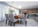 Dining room with a wood table, grey chairs, and view of the pool area through sliding glass doors at 4414 Le Reve Ct, Kissimmee, FL 34746