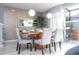 Dining room with modern table, chairs, pendant lights, and access to an outdoor grill area at 4414 Le Reve Ct, Kissimmee, FL 34746