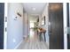Inviting entryway featuring light wood flooring, a modern console table, and a view into the brightly lit living area at 4414 Le Reve Ct, Kissimmee, FL 34746