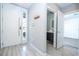 Modern entryway with white door, sleek hardware, and a view into the powder room showcasing the home's contemporary design at 4414 Le Reve Ct, Kissimmee, FL 34746
