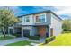 Exterior of a modern two-story townhome with attached garage and wood accents at 4414 Le Reve Ct, Kissimmee, FL 34746
