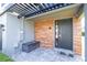 Contemporary front entrance features a dark front door, wood paneling and bench at 4414 Le Reve Ct, Kissimmee, FL 34746