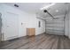 Spacious garage featuring epoxy flooring, painted walls, a modern light fixture, and plenty of room for parking and storage at 4414 Le Reve Ct, Kissimmee, FL 34746