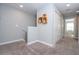Bright hallway with carpeted floors and access to various rooms at 4414 Le Reve Ct, Kissimmee, FL 34746